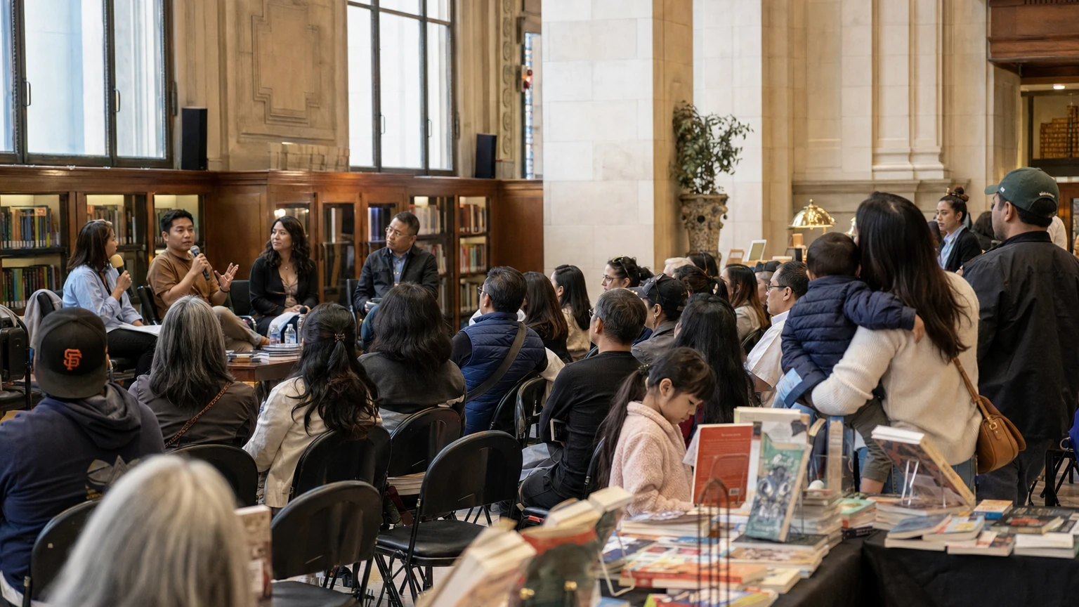 Representative editorial illustration of a literary festival inside San Francisco Main Library with author panels, books and attendees.