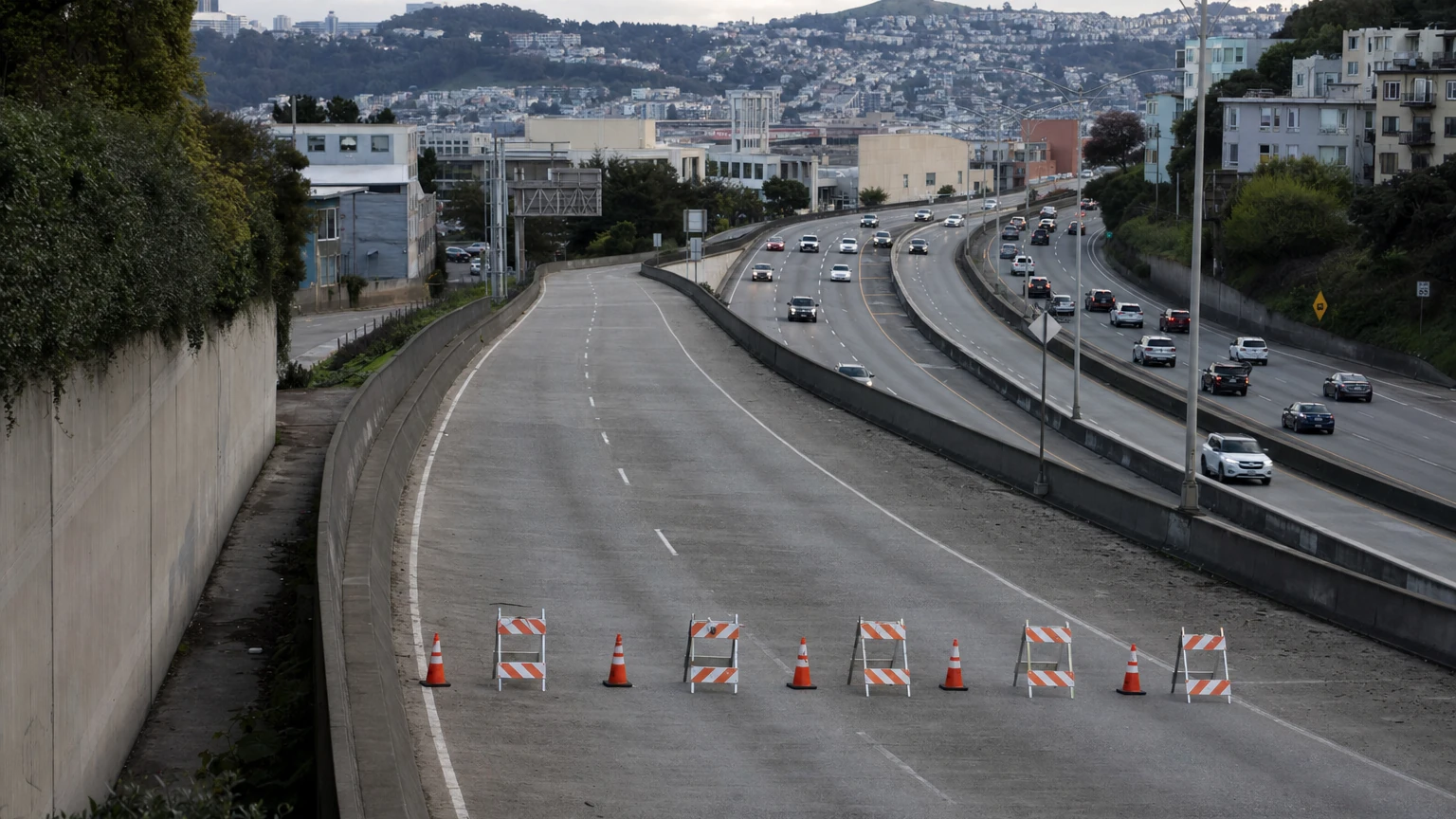 Evening traffic and pedestrians near Moscone Center in San Francisco, representing travel conditions around the Highway 101 closure weekend.