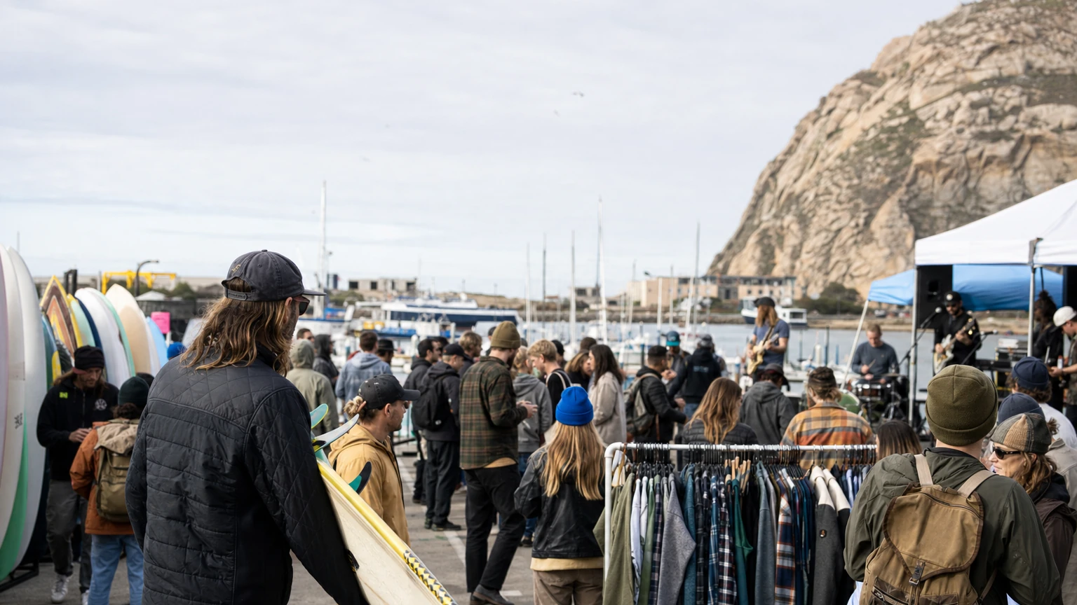 Representative editorial view of Pillar Point Harbor during a surf festival with boards, visitors, ocean-safety displays and the Pacific beyond.