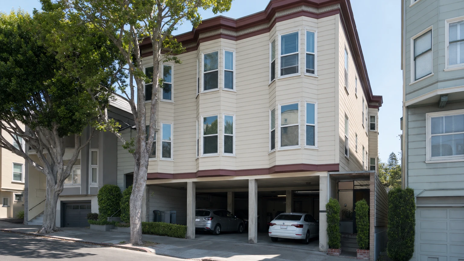 Representative San Francisco multifamily building with open garage bays at the ground floor.